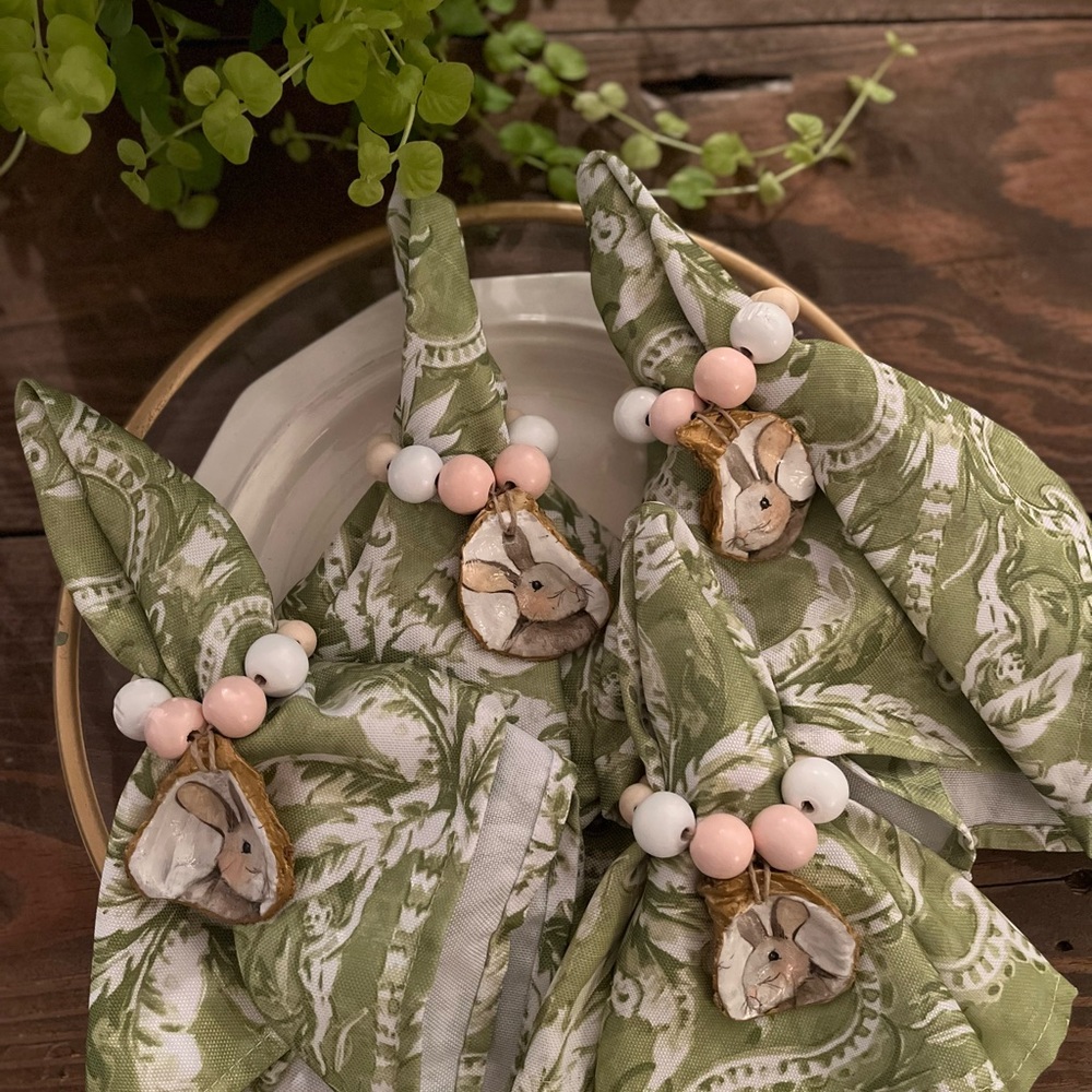 Set of four oyster shell napkin rings .